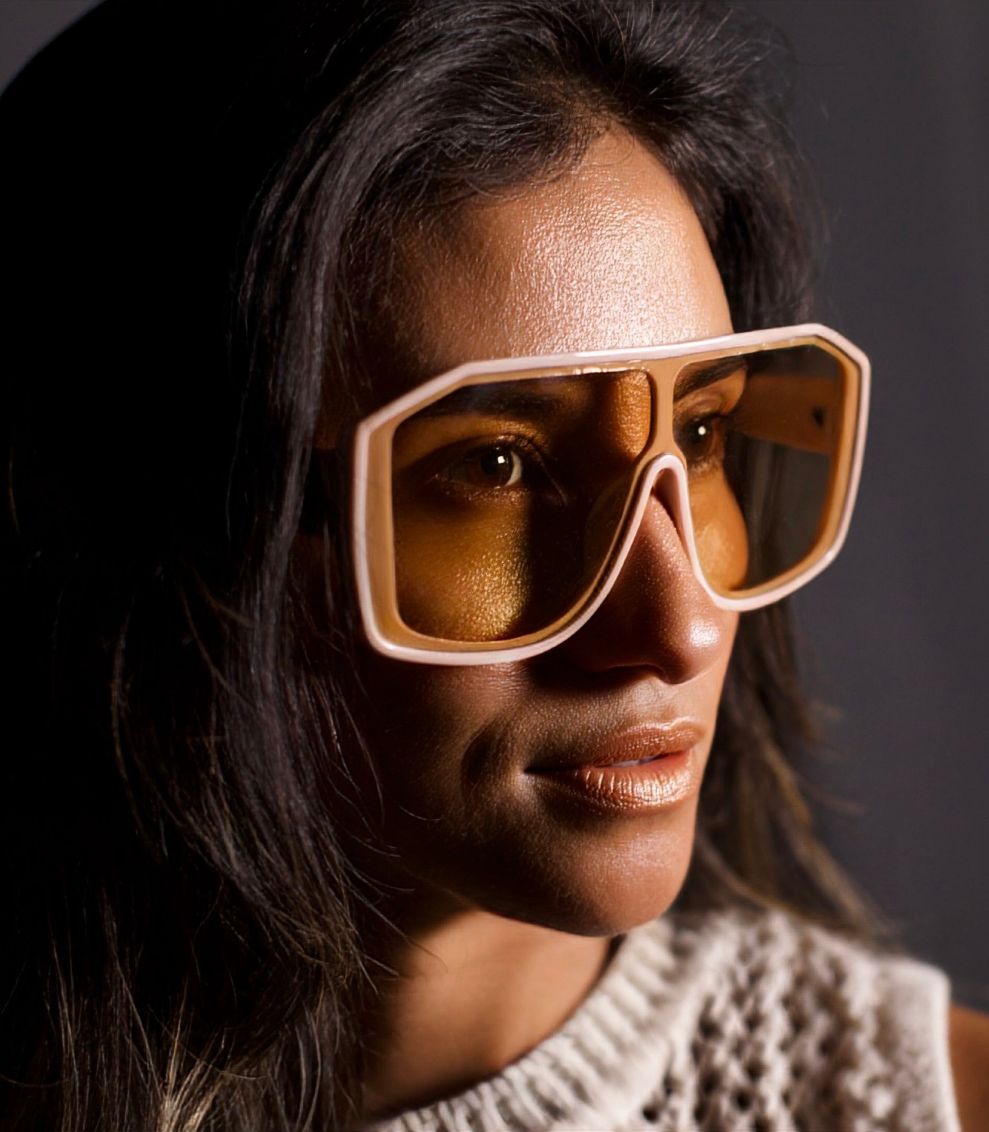 Laura, founder of Privado Eyewear, wearing the Pygmy square sunglasses in beige with tea lenses
