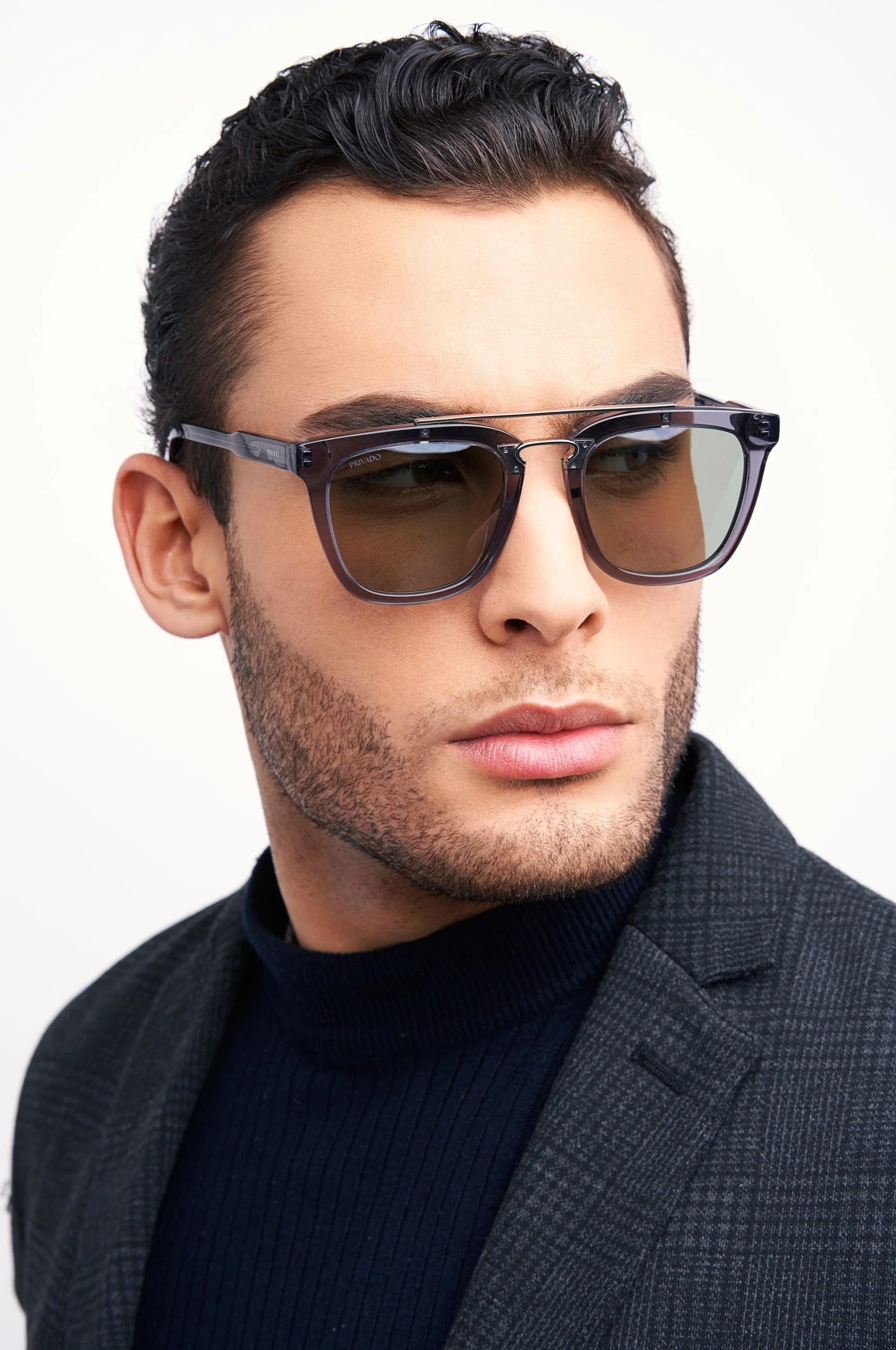 man in dark blazer and grey sunglasses