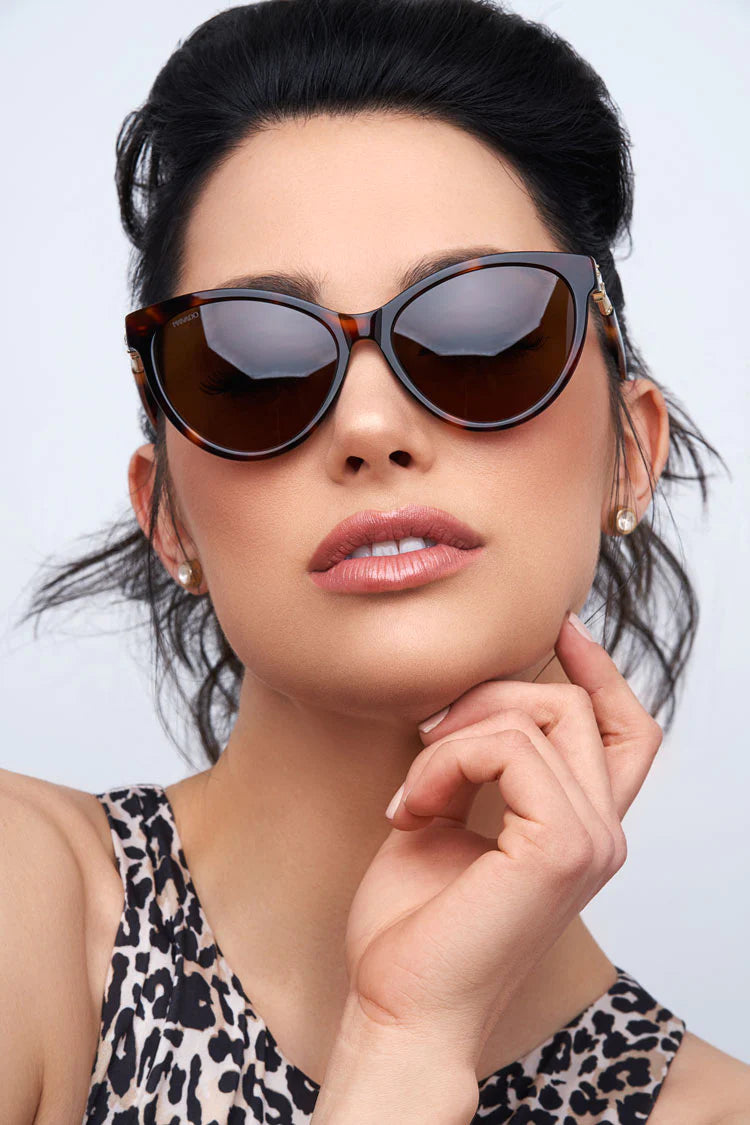 Woman wearing brown tortoiseshell sunglasses