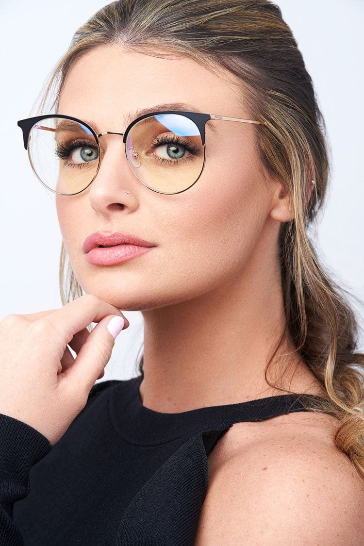 Woman wearing round blue light glasses