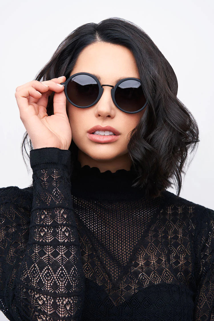 woman wearing black round frame sunglasses